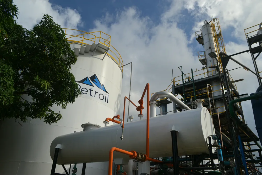 Columna de proceso, tuberías y tanque de la refinería vistos desde abajo.